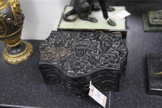 A 19th century serpentine shaped Ceylonese ebonised wood box, 10.75in.